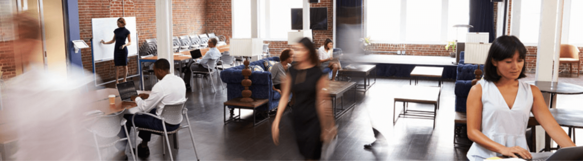 blurred image of the inside of an office, employees actively working concept
