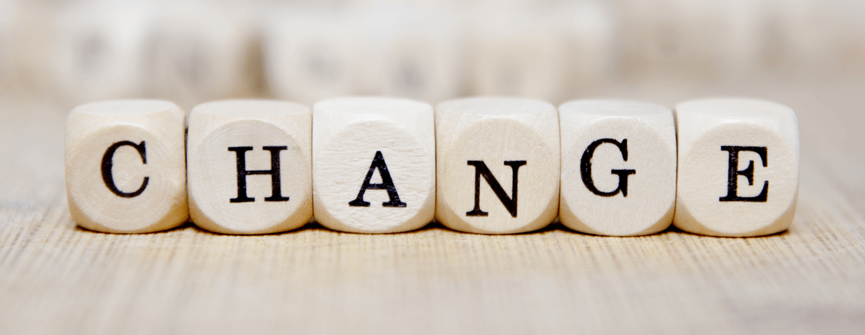 Wooden blocks that spell out the word change on a table 