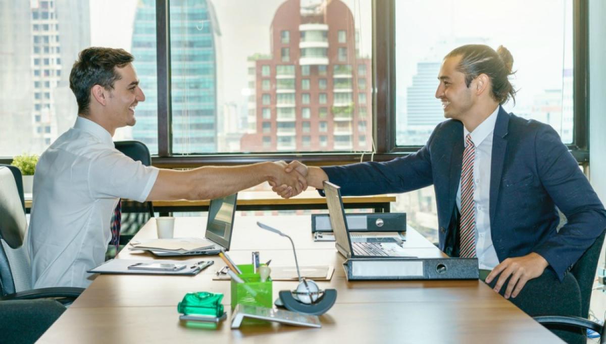 Two Men in an Office Shaking Hands