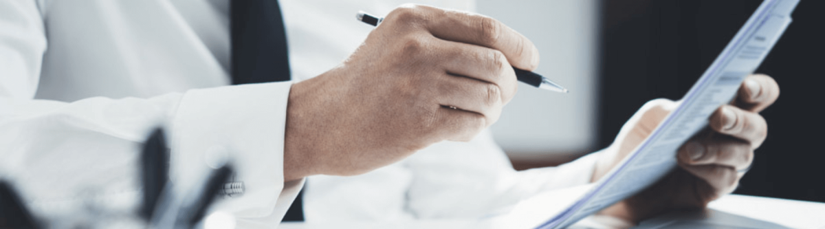 lawyer or businessman in a shirt and tie holding a pen near a document or contract, legal industry concept