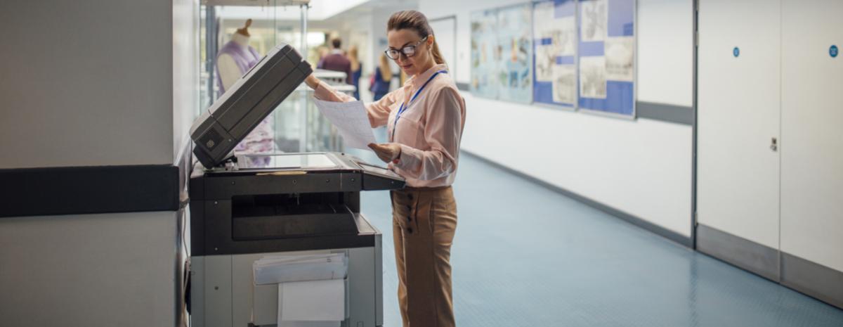 teacher using a printer in hallway